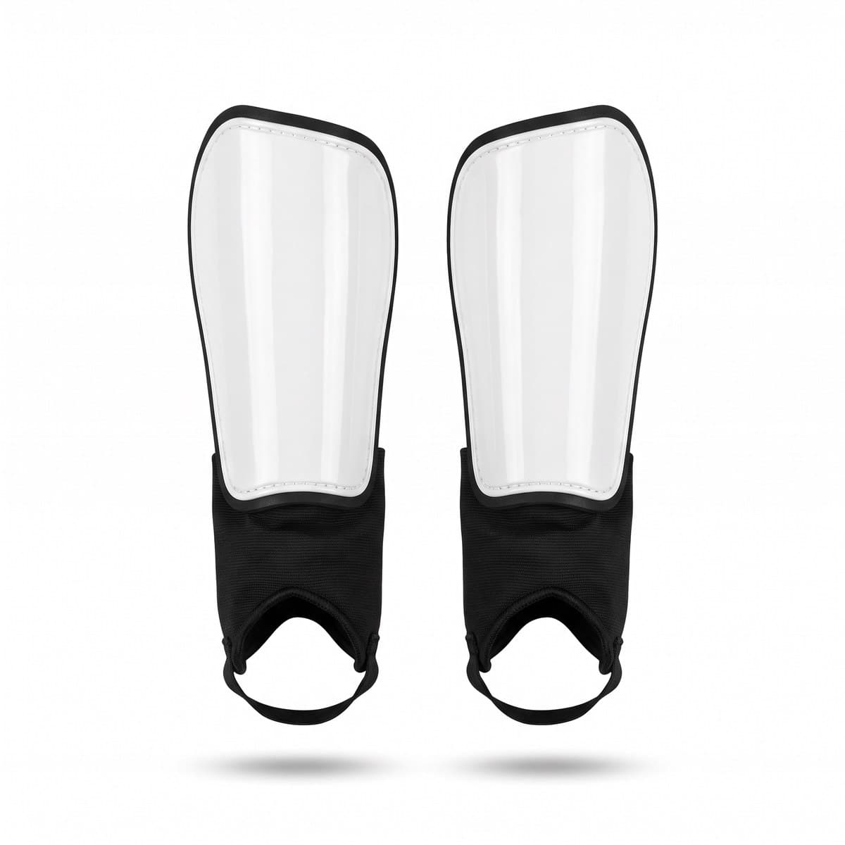 A pair of black and white soccer shin guards with black ankle sleeves, standing side by side